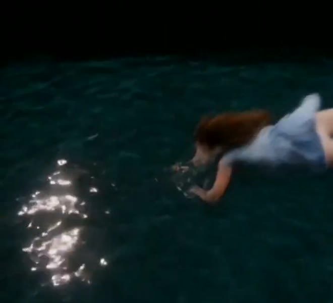 Lily in the water in her party dress
